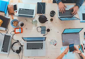 people using gadgets at a table