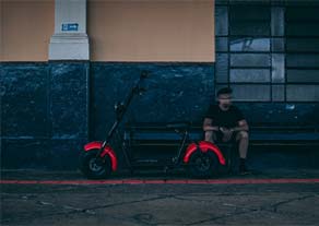 Man by electric scooter